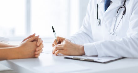 close up of patient and doctor taking notes