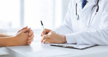 close up of patient and doctor taking notes