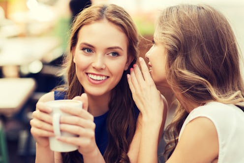 people communication and friendship concept - smiling young women drinking coffee or tea and gossipi...