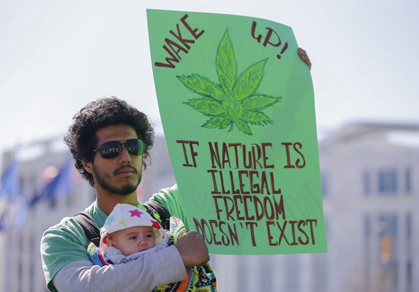 Julio Mijangos Holds His Daughter Kaya and a Sign While Participating in the Pro Marijuana Rally For...