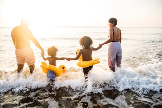 Black family having fun on the beach