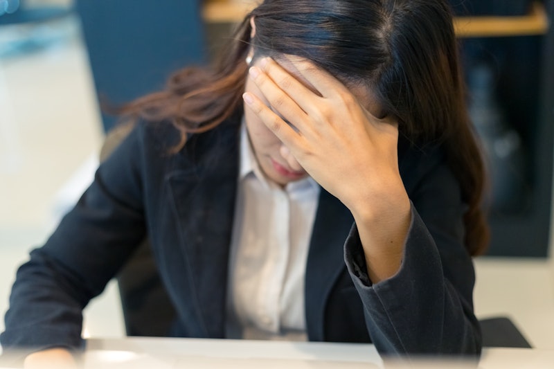 Asian business woman stress from work in the office