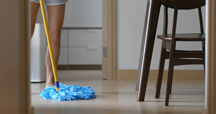 Woman clean the floor at home with mop