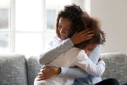 Loving single black mother hugging african daughter caressing cuddling, caring mom embracing support...