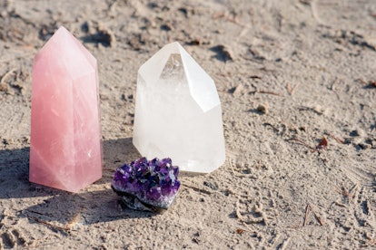 Golden Triangle gemstones: amethyst, rose quartz and white quartz, standing together on the beach