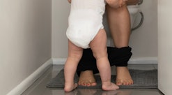 Baby follows mother to the toilet