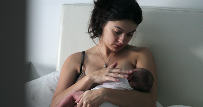 
Candid mom breastfeeding infant newborn baby, new mother showing love and affection