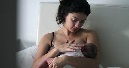 
Candid mom breastfeeding infant newborn baby, new mother showing love and affection