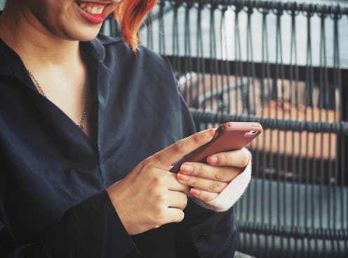 Woman using smart phone on hand