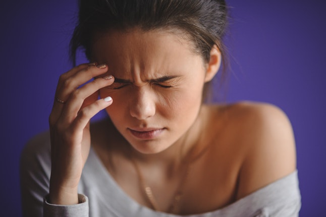 Close up Portrait of young woman with headache