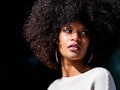 Portrait of attractive afro woman in over the wall. Hair style concept