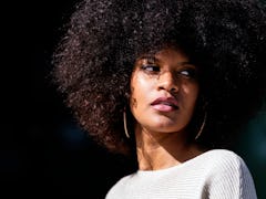 Portrait of attractive afro woman in over the wall. Hair style concept