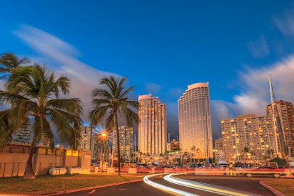 Luxurious hotels overlooking the Ala Wai Harbor at twilight and the light trails in Honolulu, Oahu, ...