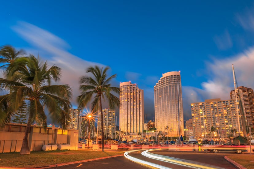 Luxurious hotels overlooking the Ala Wai Harbor at twilight and the light trails in Honolulu, Oahu, ...