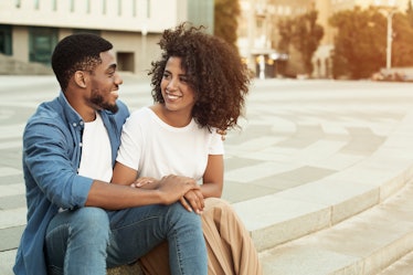 African-american couple talking, enjoying date, walking outdoors in city