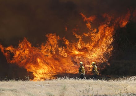 A hillside erupts in flame as a wildfire burns in Placerita Canyon in Santa Clarita, Calif., . The s...