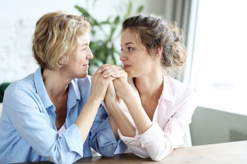 lifestyle and people concept: Happy senior mother embracing adult daughter laughing together, smili...