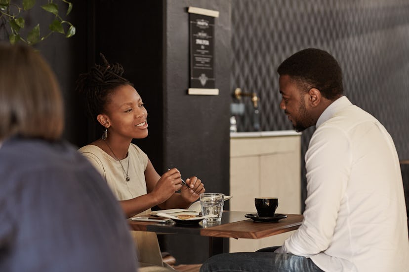 African couple enjoying coffee date in a modern cafe