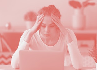 Stressed frustrated young woman student looking at laptop reading bad email internet news feeling sa...