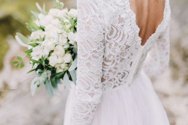 Bride holds a wedding bouquet, wedding dress, wedding details