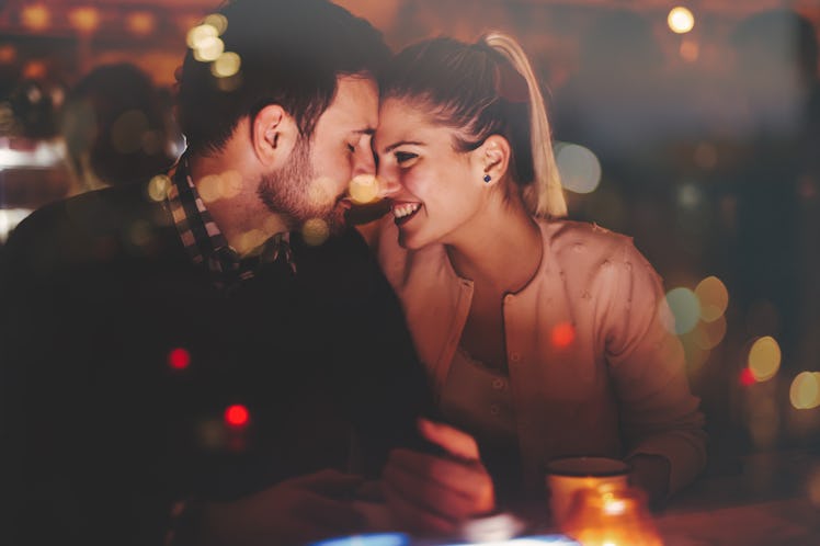 Romantic couple dating in pub at night