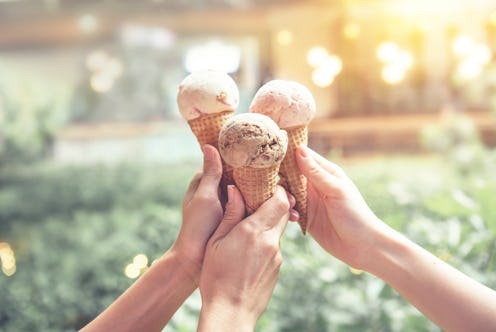 Young woman hands holding ice cream cones on summer
