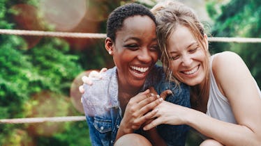 Cheerful girls embracing each other, showing each other they love them