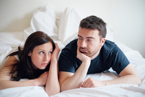 Worried and bored lovers couple after a fight lying in the bed