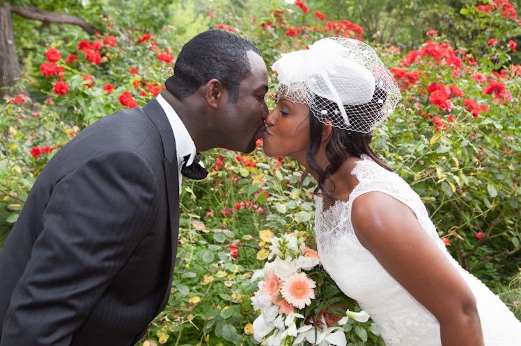 kiss between pretty wedding couple