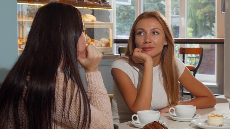 Attractive woman talking to her best friend at the coffee shop