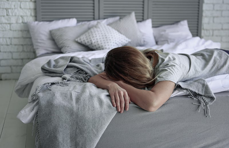 Deeply upset woman on bed