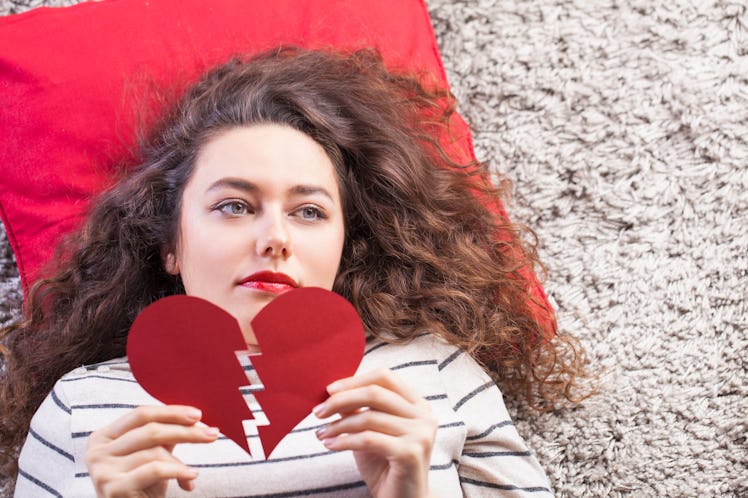 Sad woman hand hold broken heart. Relationship breakup or valentine day concept.