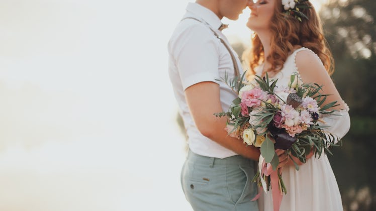 the bride and groom on the background of a mountain stream