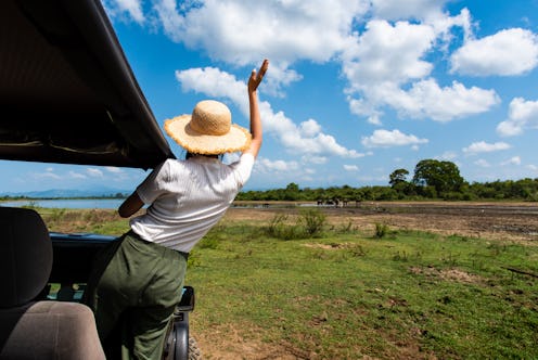 Woman enjoying the view from the safari truck