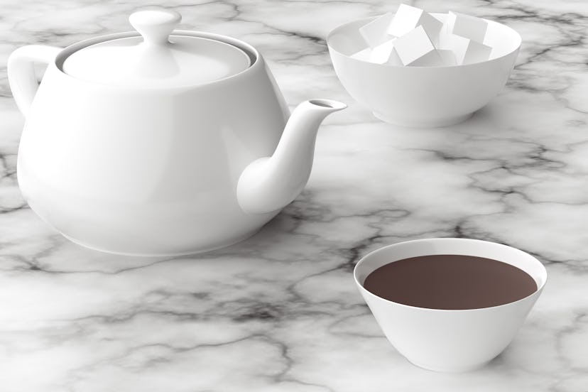 A mug of strong tea next to a teapot and sugar