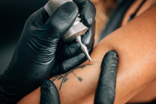 woman getting a tattoo