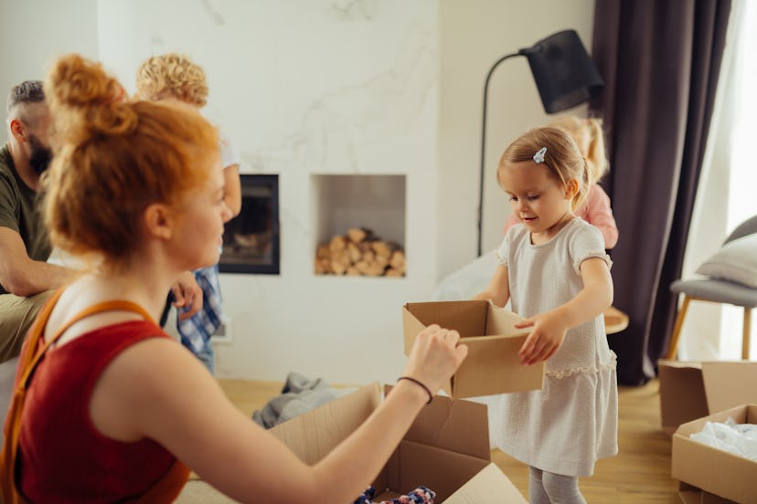 So helpful. Nice pretty girl bringing a box to her mother while wanting to help her