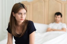 Unhappy couple not talking after an argument in bed at home. People, relationship difficulties and f...