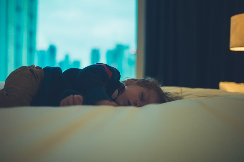 A little toddler is sleeping in a city apartment