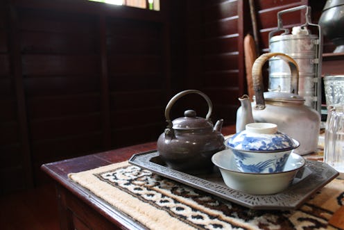 old antique vintage Thai style silverware, ceramic, brass tea pot and tea cup