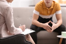 Psychotherapist working with young man in office, closeup