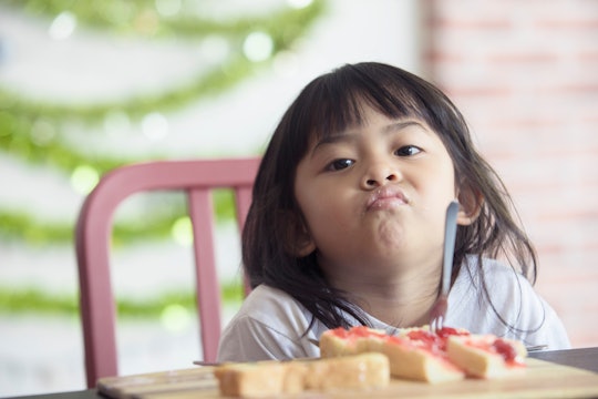 cute baby eating boring food,Asian baby bored looking face looking at her breakfast,Children with br...