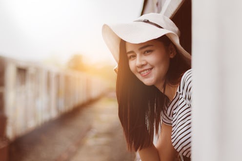 Asia woman travelling by train alone with fun and happy.