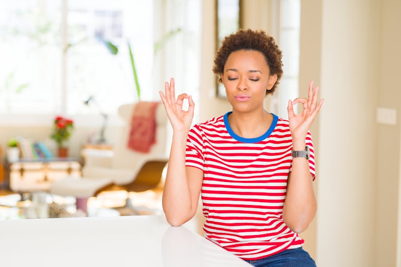 Young beautiful african american woman at home relax and smiling with eyes closed doing meditation g...