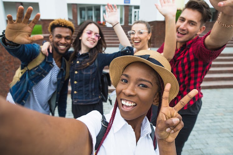 students with beaming smiles are posing for selfie shot
