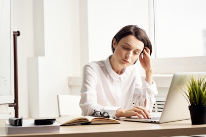 tired woman behind laptop                              