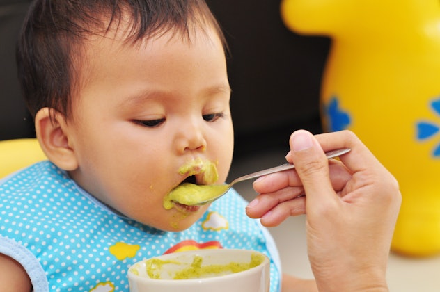 feeding baby food to baby