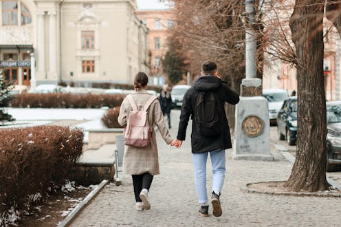 Wallking together. Full length of young couple on date having fun together. They are going hand in h...