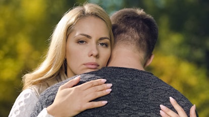 Upset couple hugging, looking wistful, fatal disease diagnosis, support and care