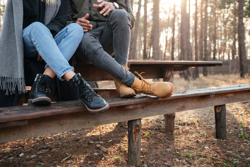 Cropped image of loving couple sitting outdoors in the forest.